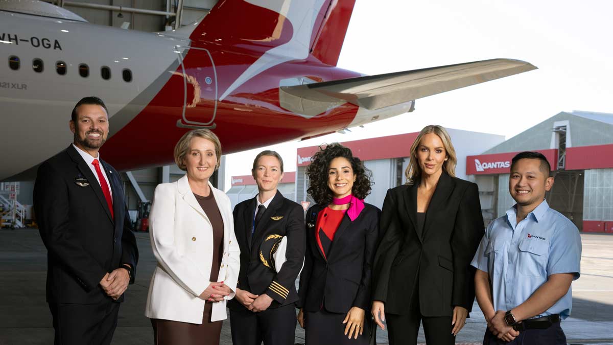 a group of women standing in front of an airplane