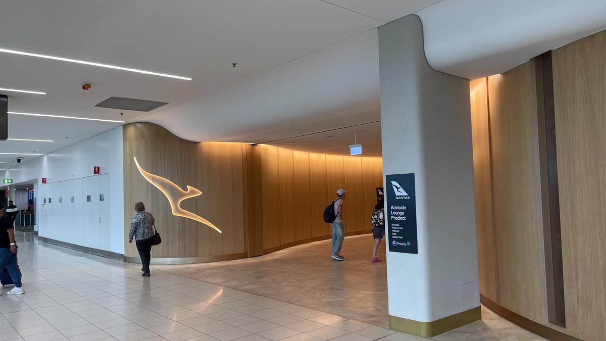 people in a building with a wall and a sign