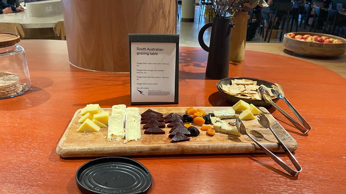 a board with different types of cheese on it