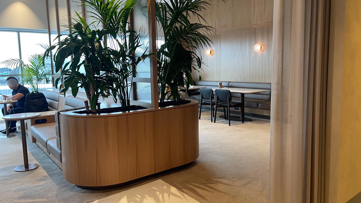 a room with a table and chairs and a planter