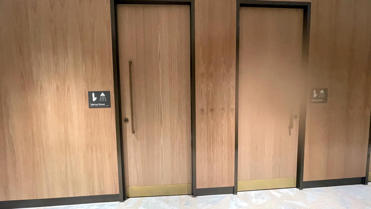 a two doors with a sign on the wall