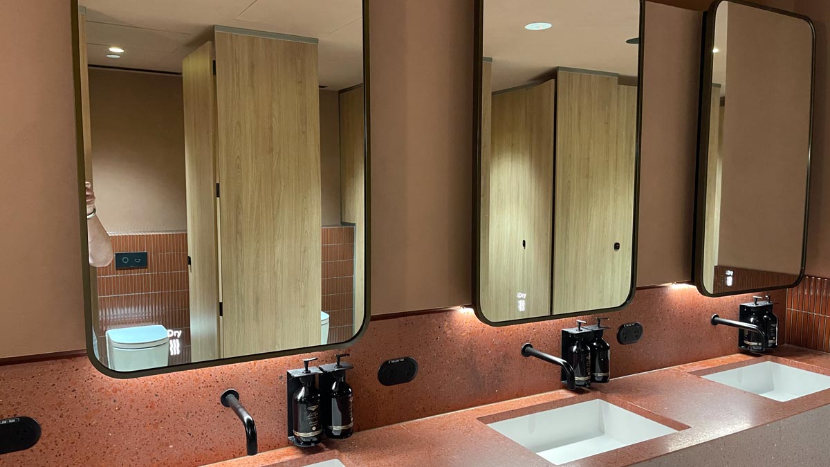 a bathroom with two mirrors
