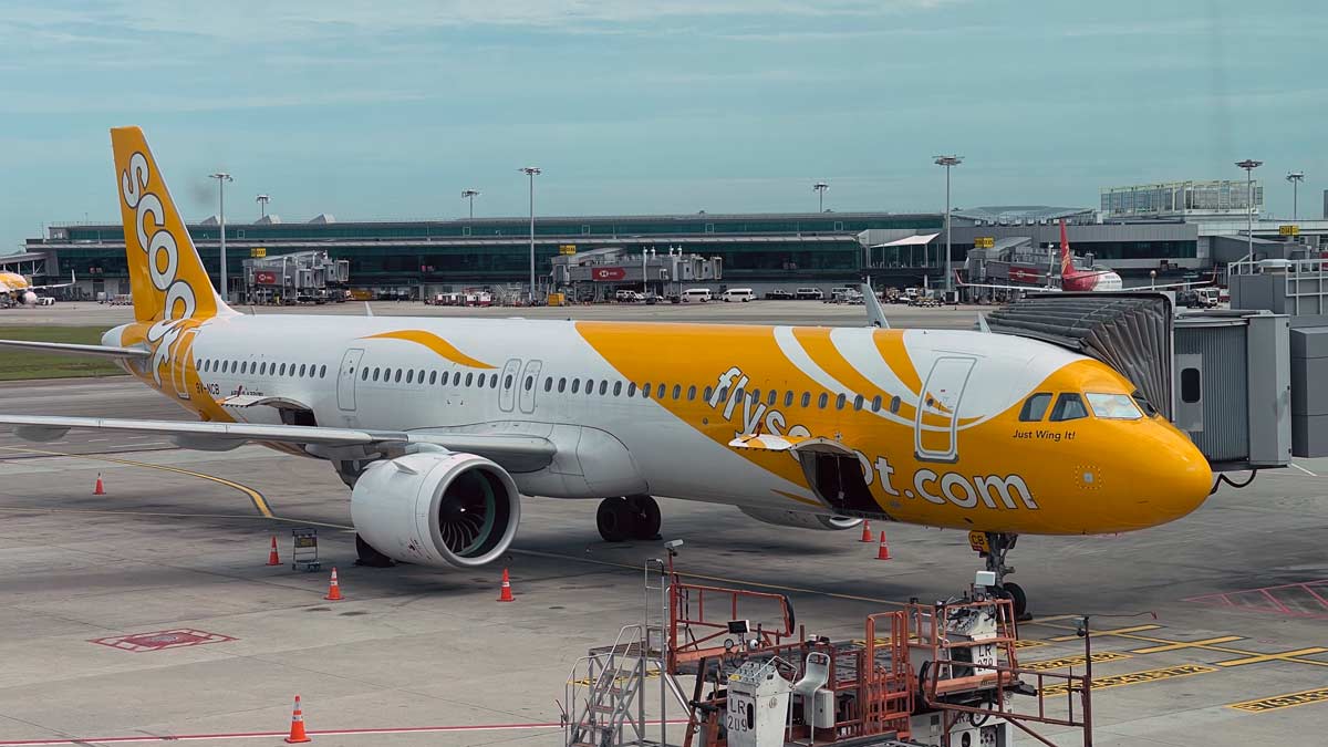 a yellow and white airplane on a runway
