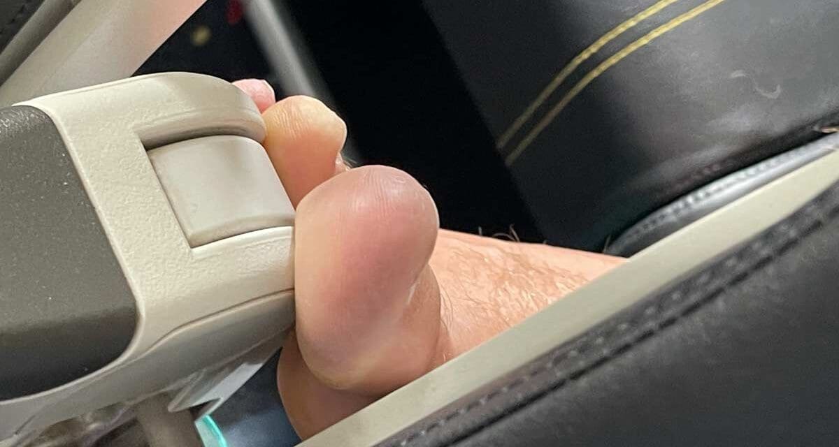 SCOOT: Disgusting passenger — feet on my armrest