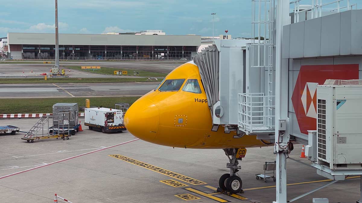 a yellow airplane at an airport