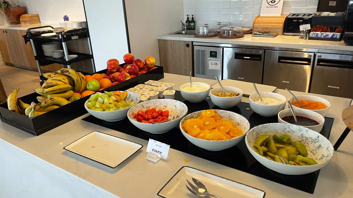 a table with bowls of fruit and other food