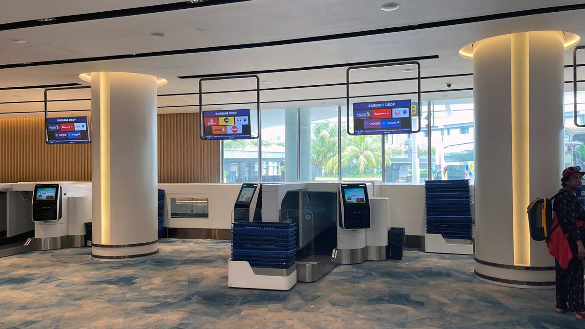 a check in area with electronic screens