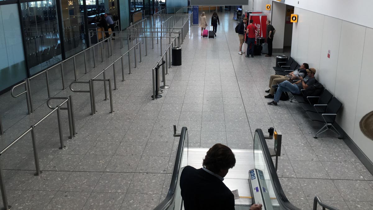 people sitting on an escalator in a airport