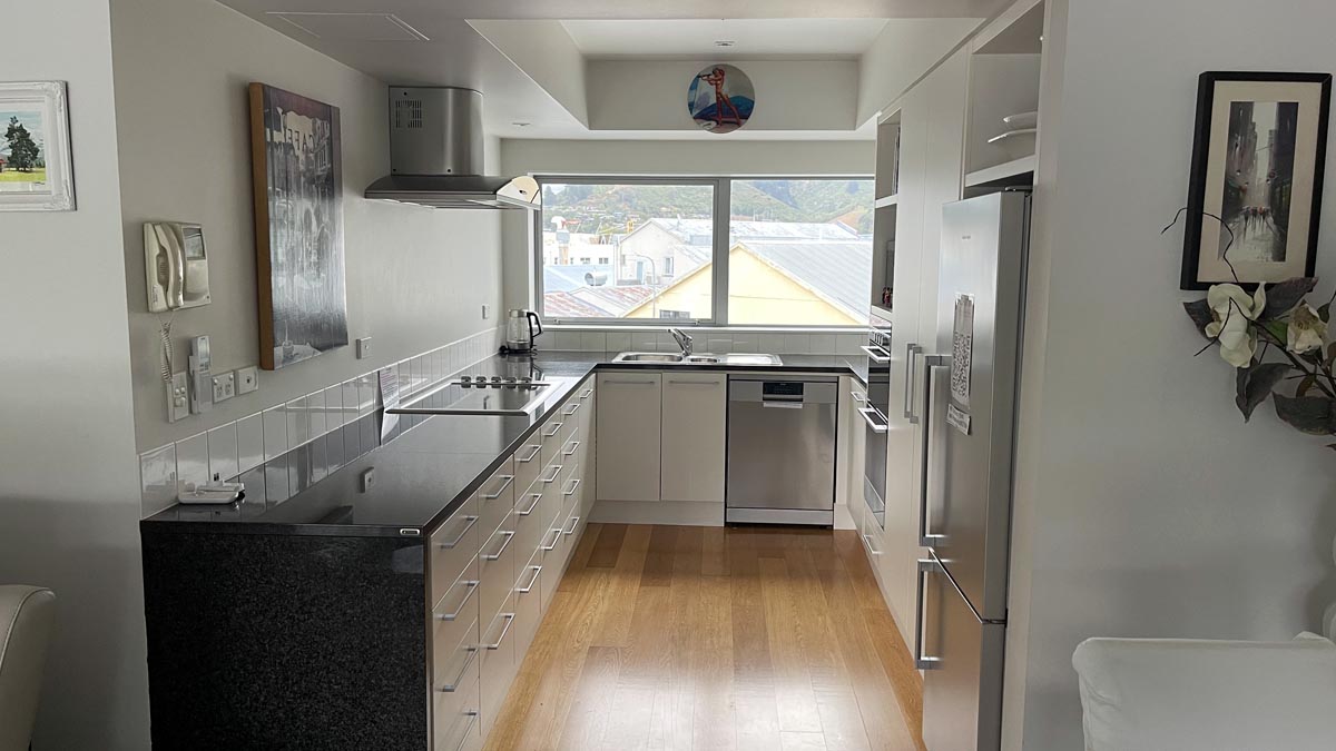 a kitchen with white cabinets and a wood floor