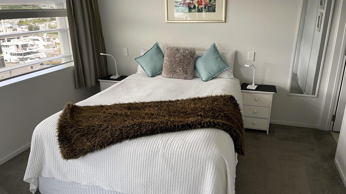 a bed with pillows and a brown blanket