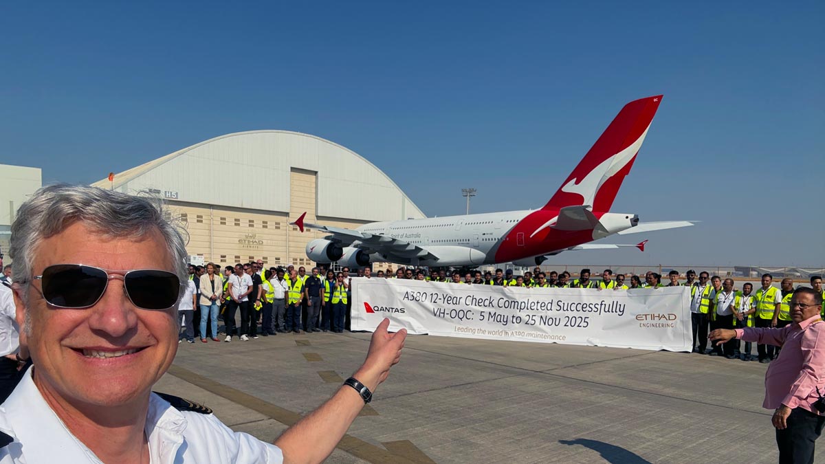 a group of people standing in front of a plane