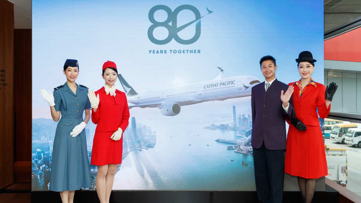 a group of people standing in front of a large screen