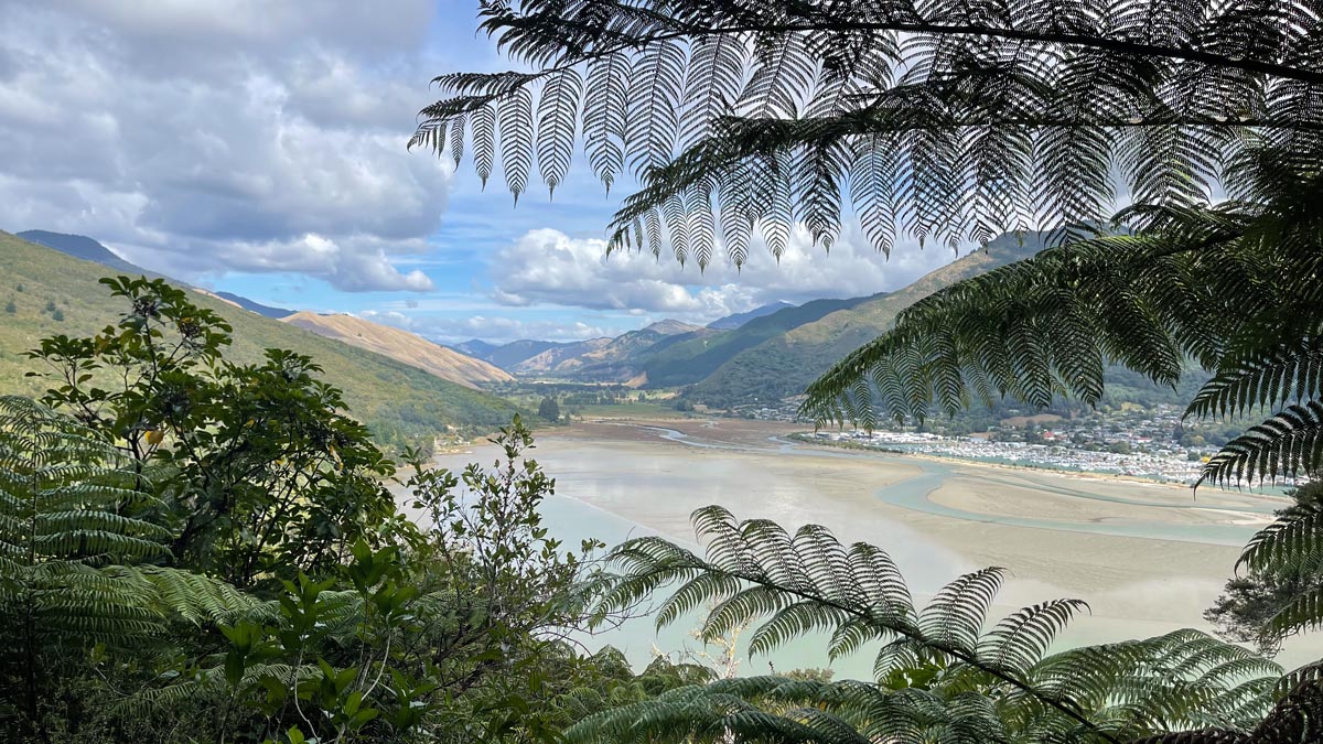 a view of a river and mountains from a hill