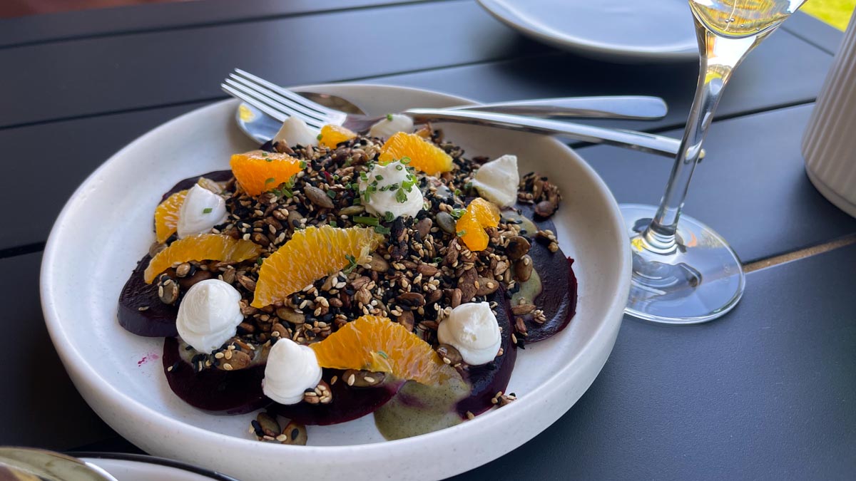 a plate of food with oranges and cream on it
