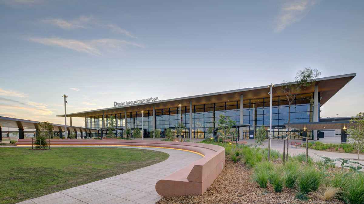 a building with a curved walkway and grass