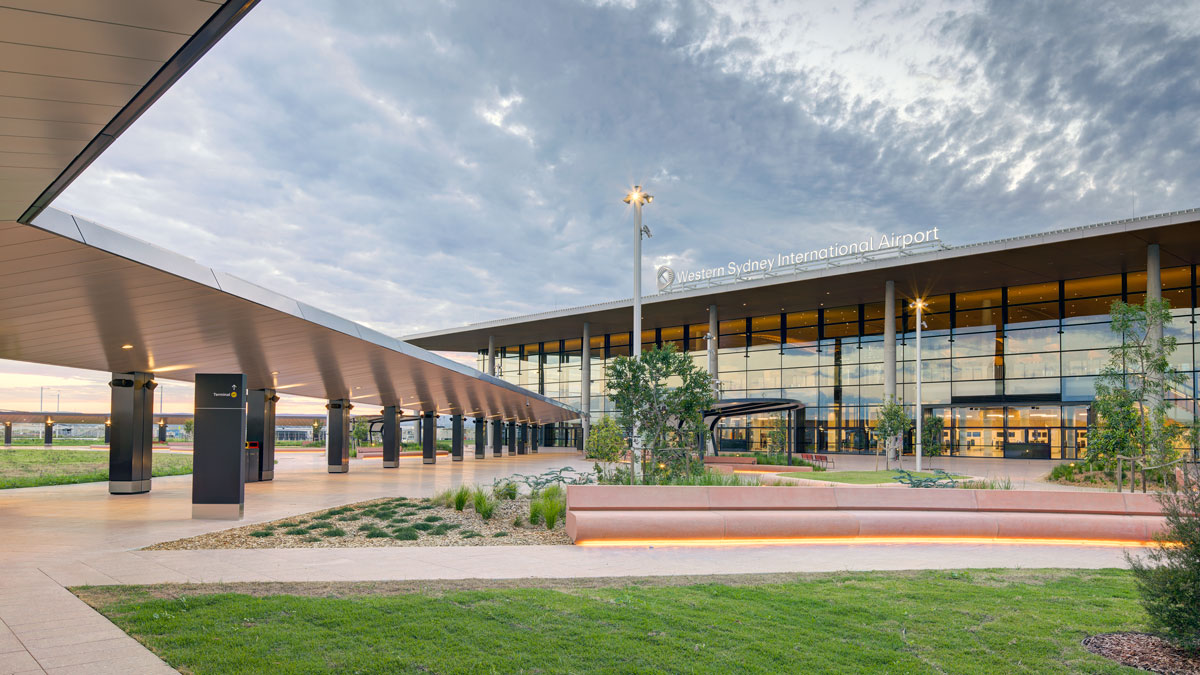 a building with a large glass building and a walkway