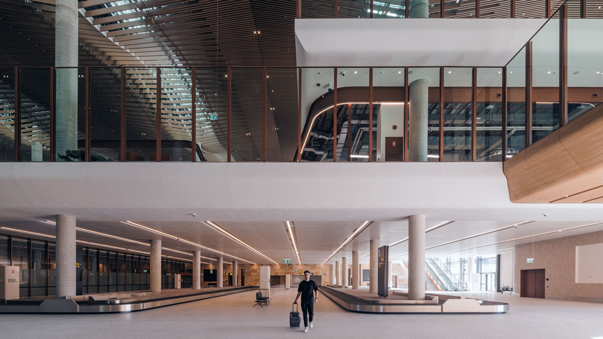 a man walking with a luggage in a large building