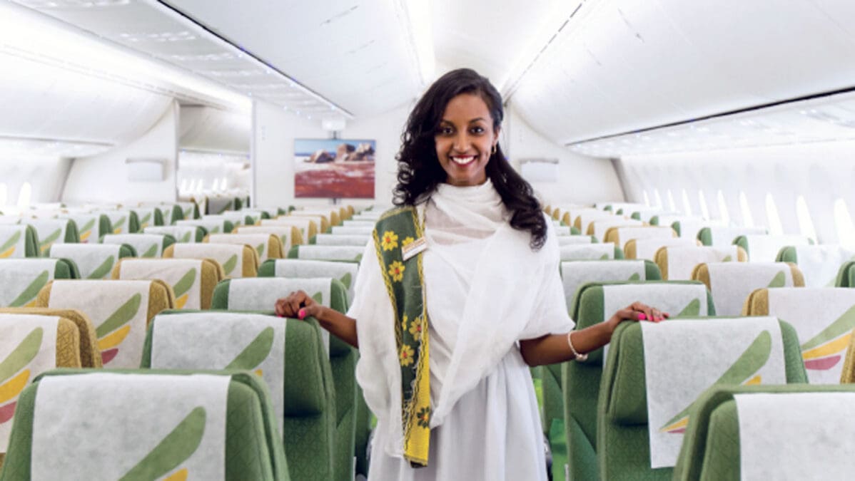 a woman standing in an airplane