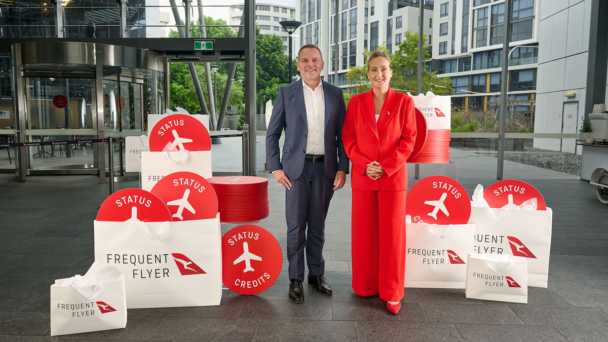 a man and woman standing in front of a sign